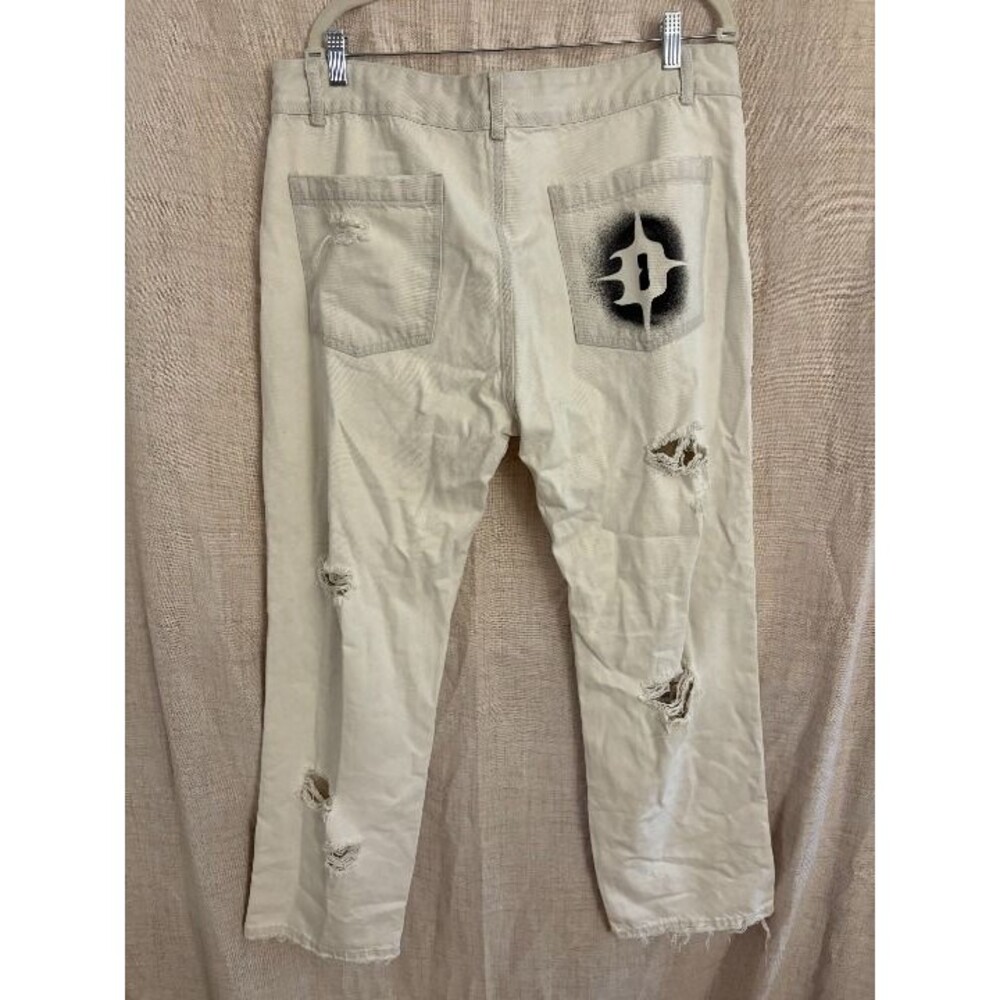 Darker Wavs shredded jeans
